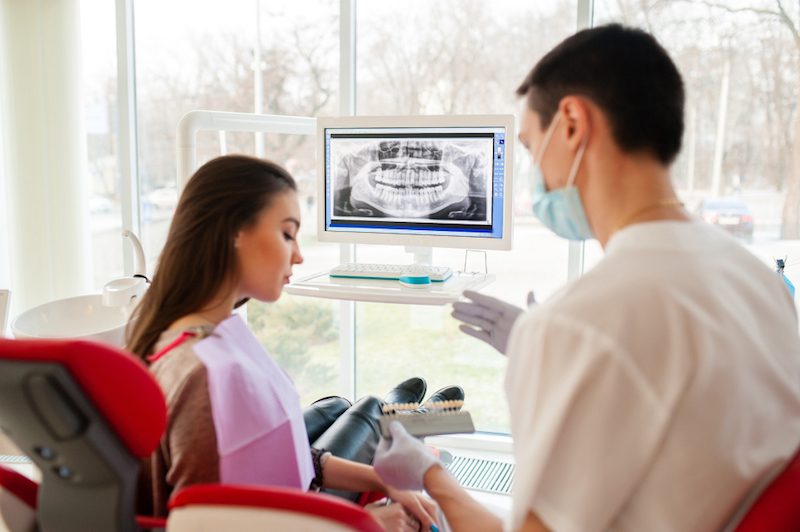 dentist-selects-color-dental-implants-beautiful-girl-2.jpg