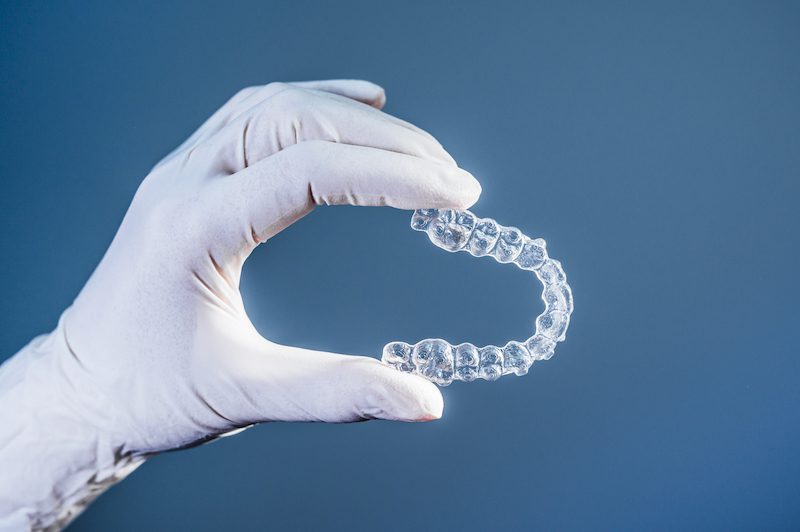 doctor-hand-holding-clear-dental-aligner-copy.jpg